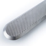 Tactile ground surface indicator made of stainless-steel with diamond pattern on top.